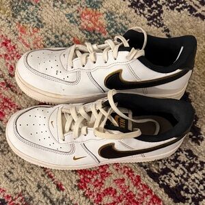 Nike White Sneakers with Black and Gold Accents